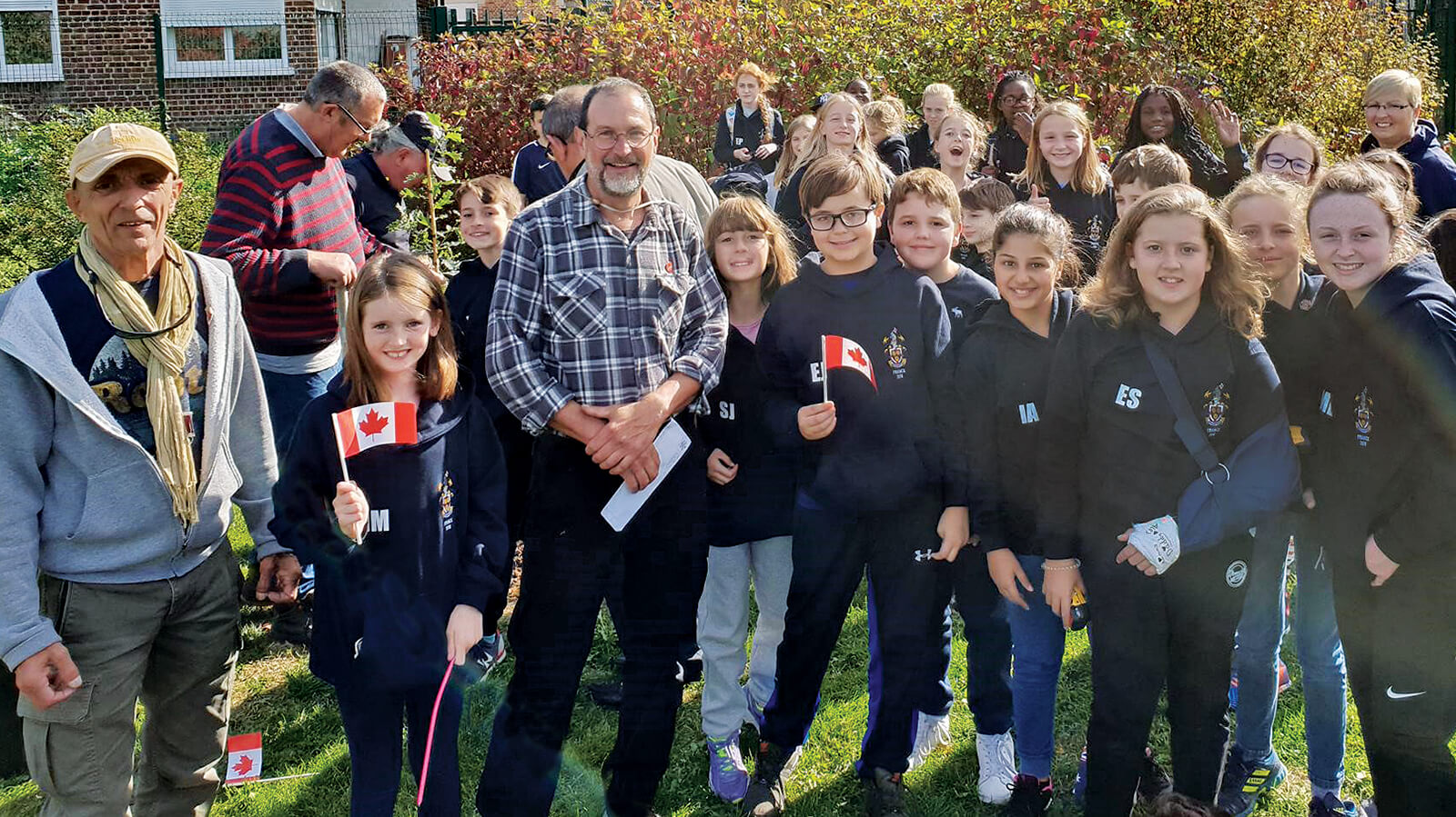 group of school children and adults pose for a group photo with the authour