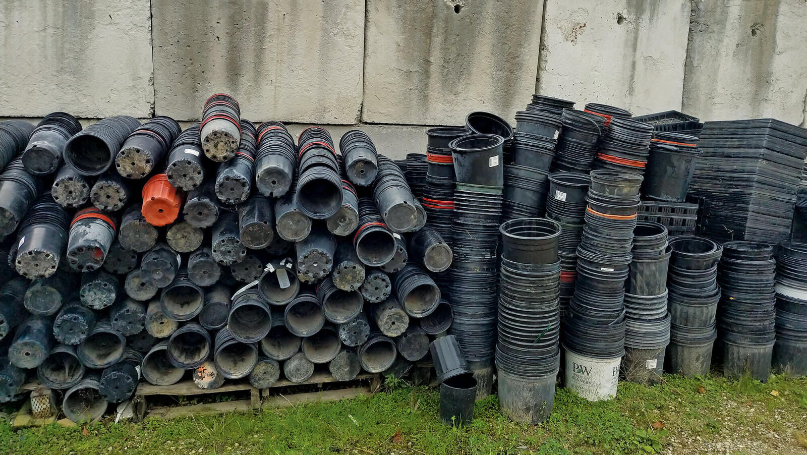 huge pile of used plastic pots for recycling