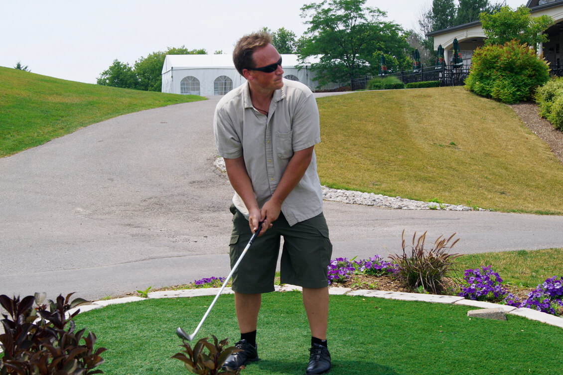 man about to tee off on a golf hole
