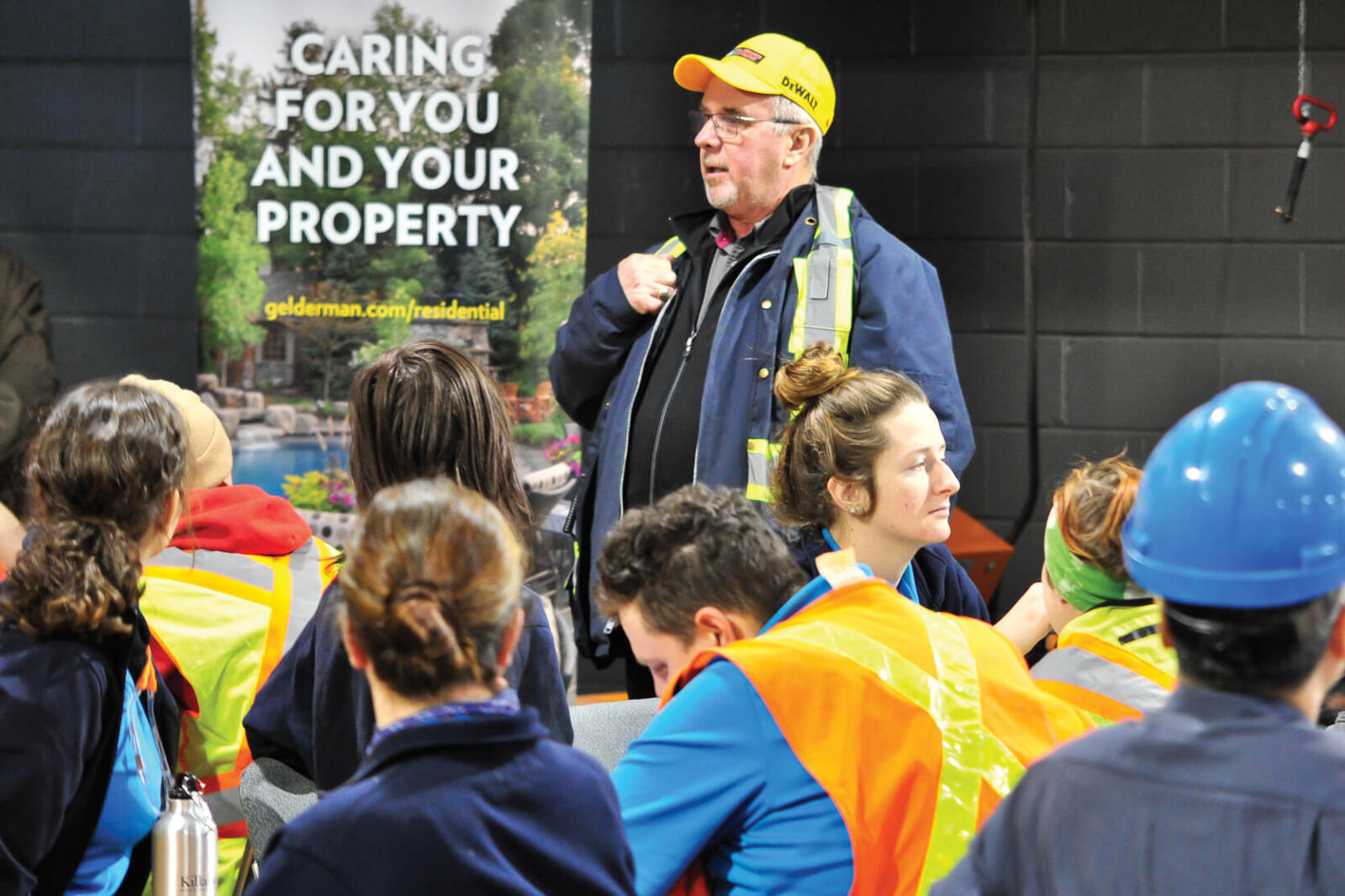 man talking to a group of students