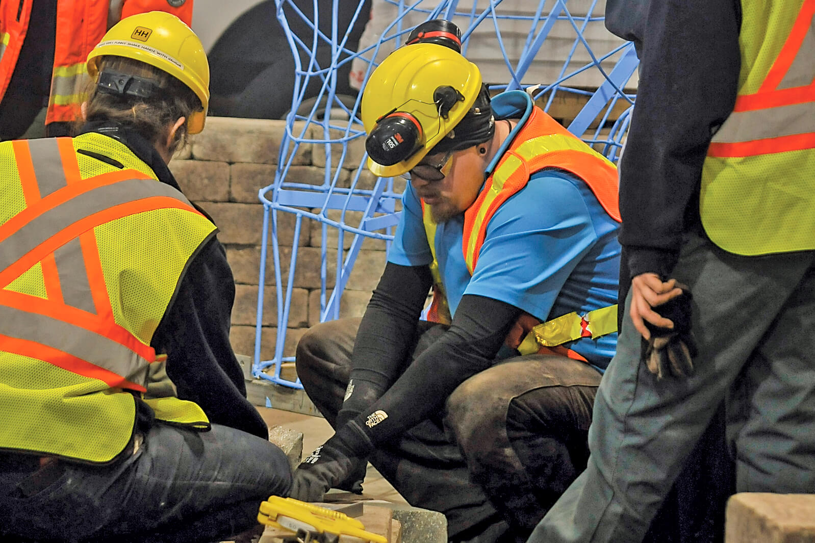 people building a garden at a trade show