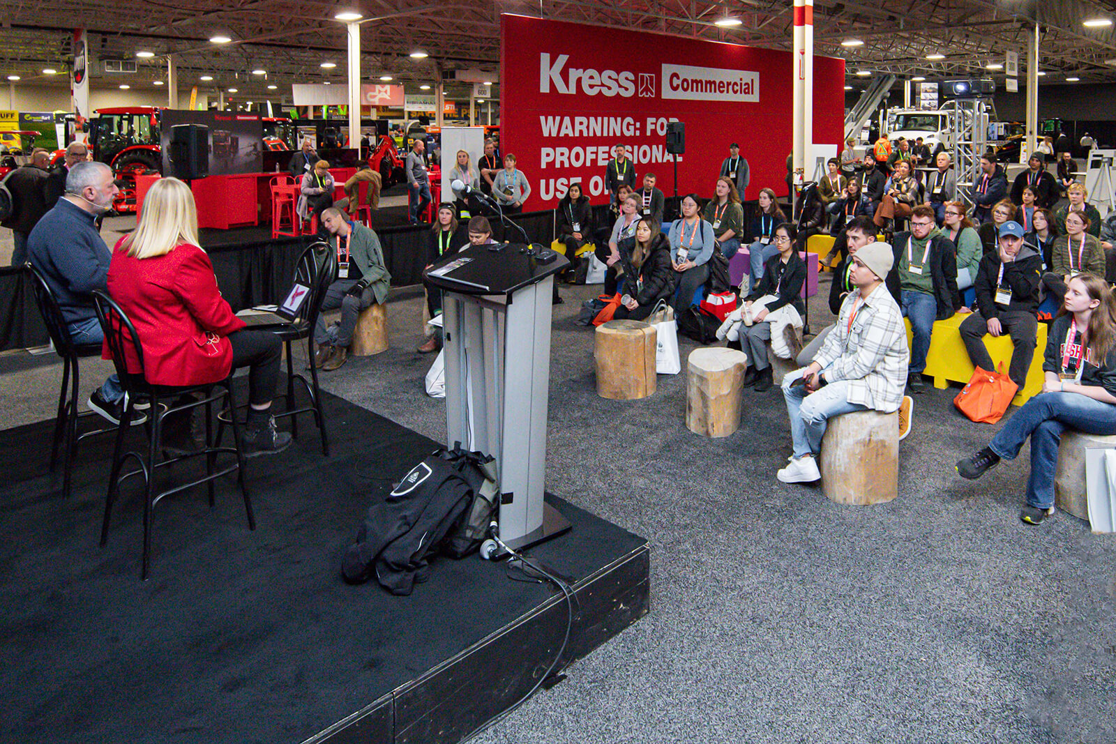 people talking to an attentive crowd