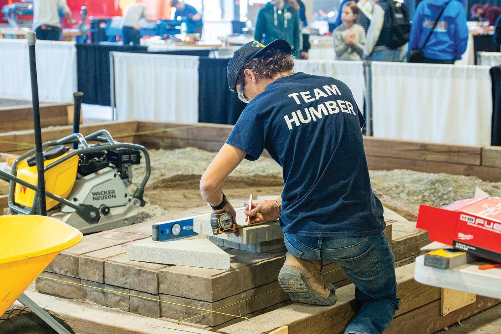 competitior using a tape measure and level